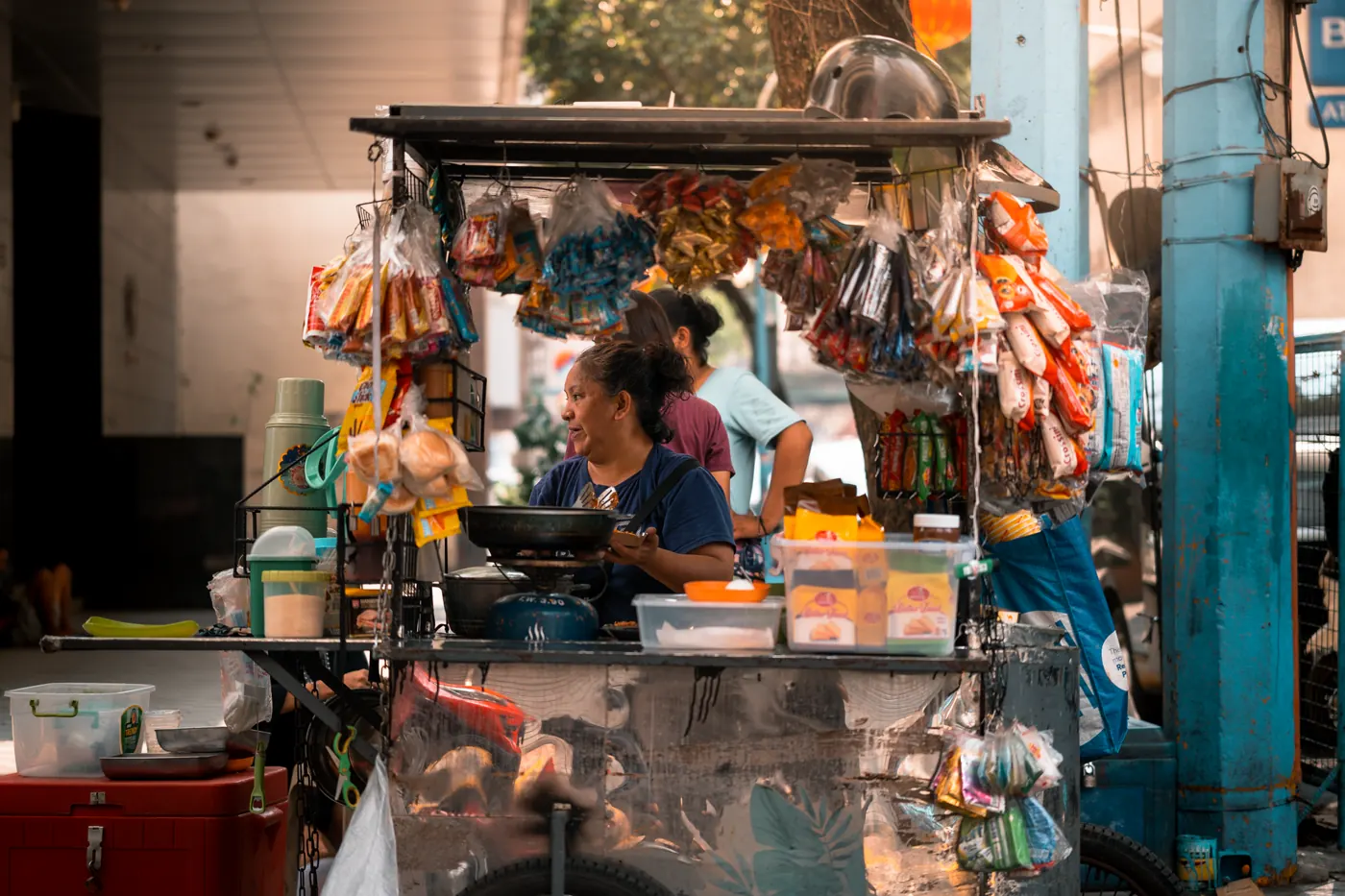 A street-food vendor serving customers in Manila